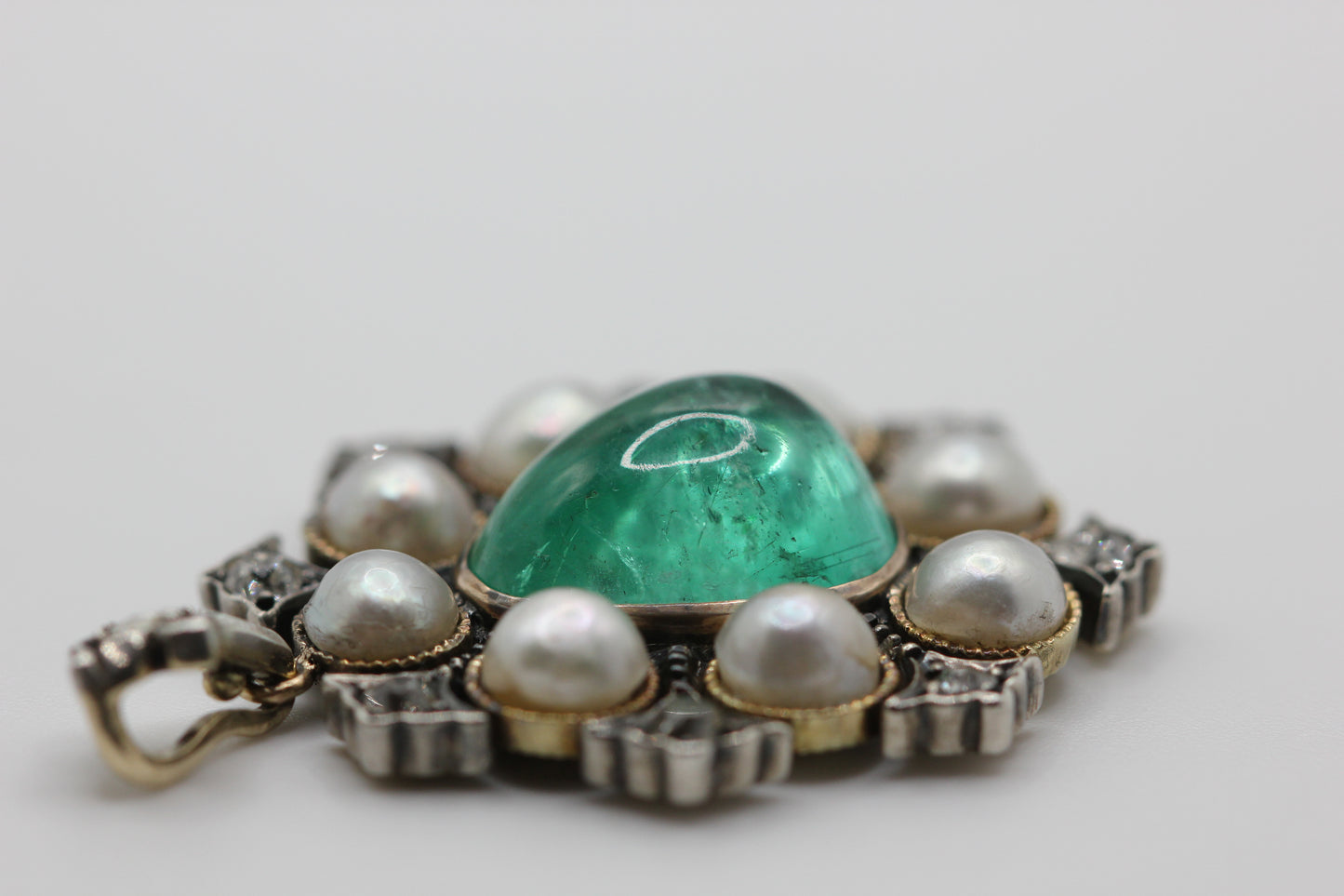 A natural saltwater pearl and emerald pendant