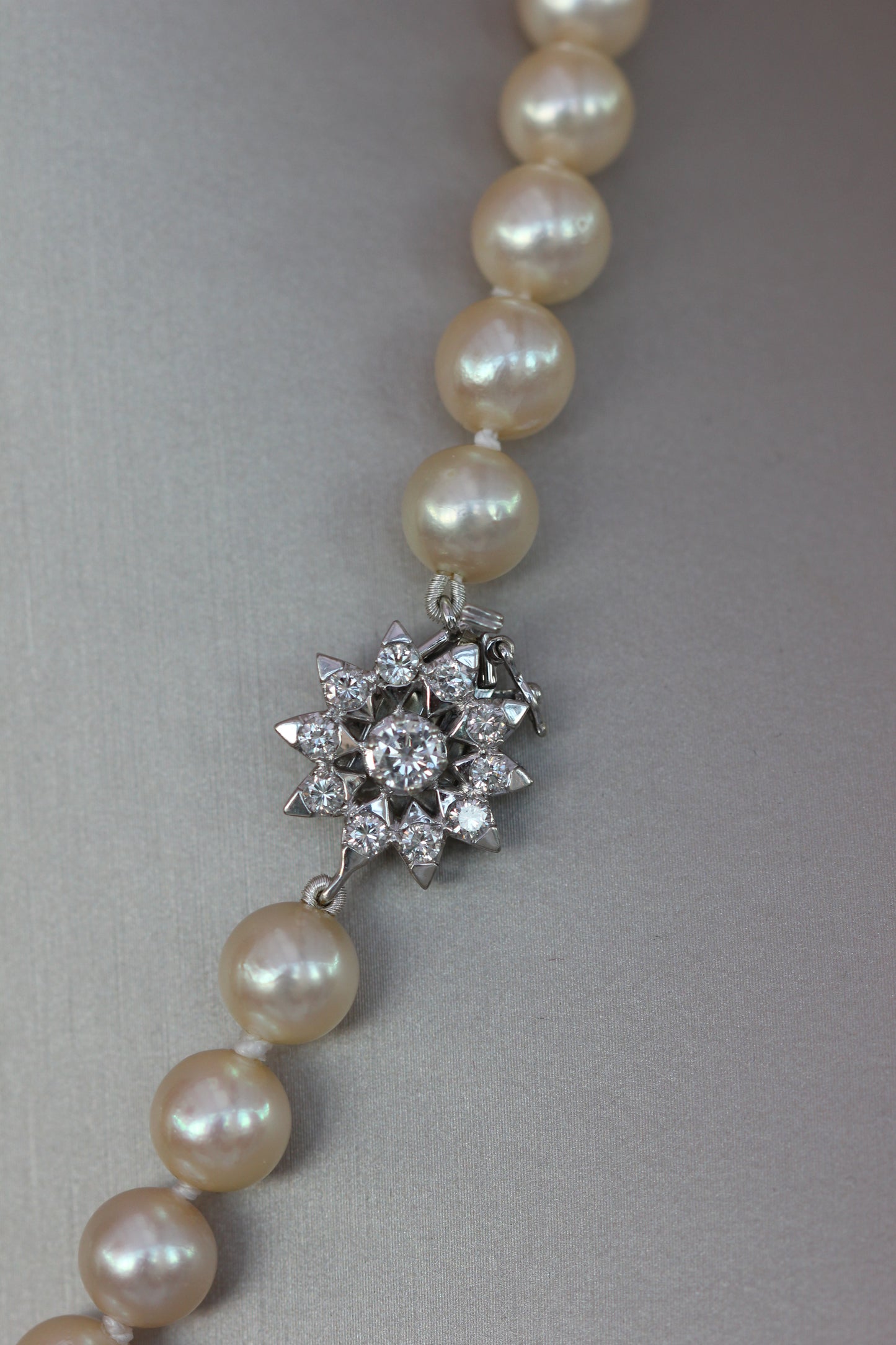 Pearl necklace with diamond flower clasp