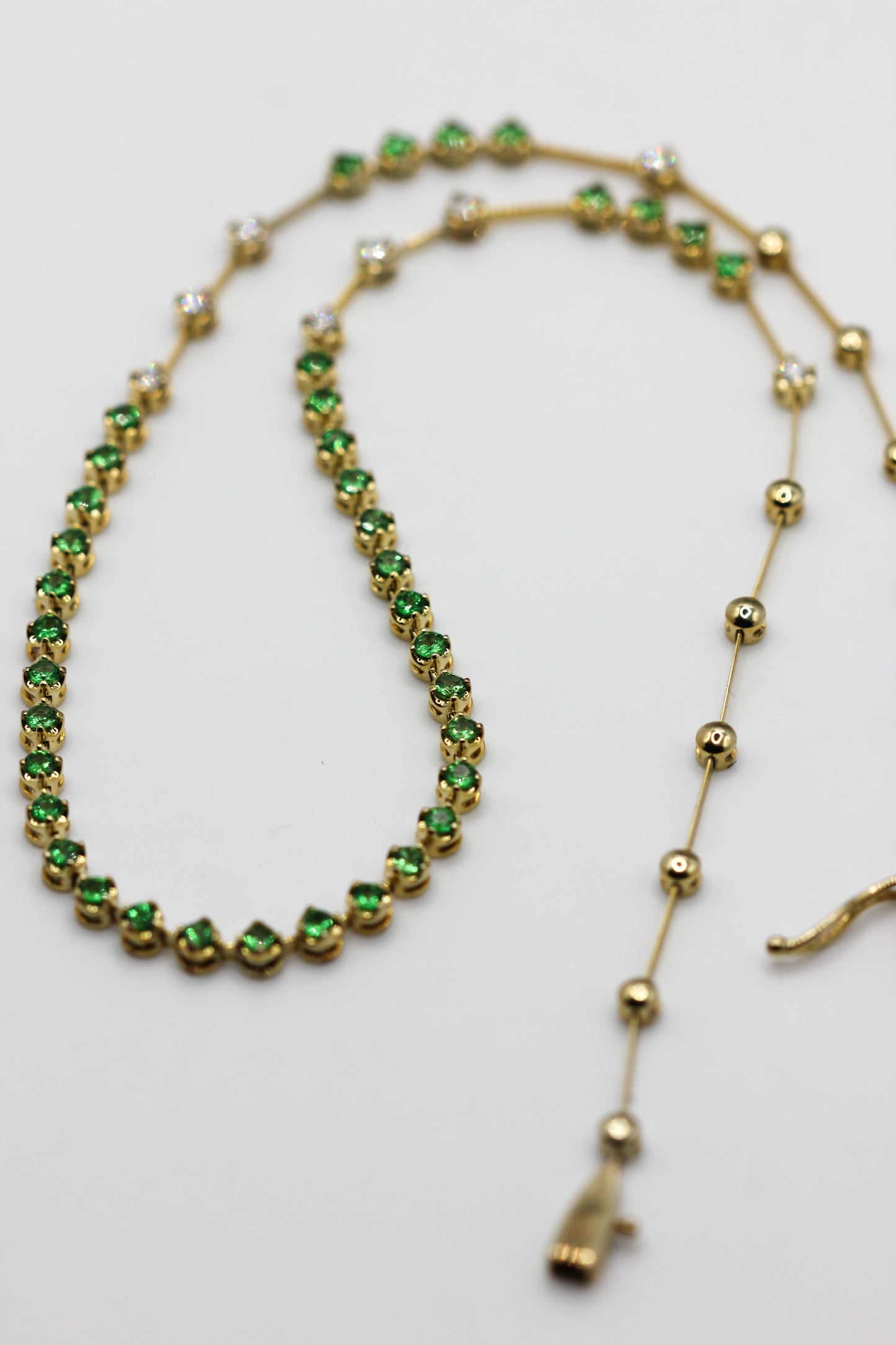 Emerald and diamond line necklace
