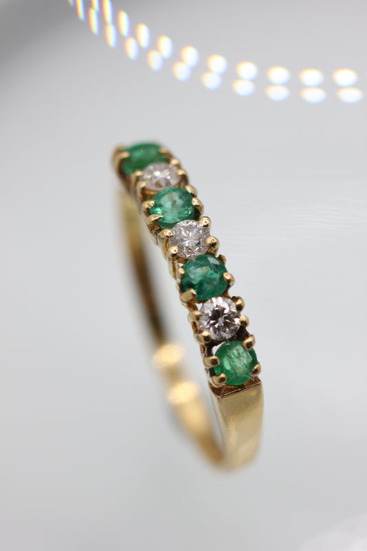Emerald half eternity ring